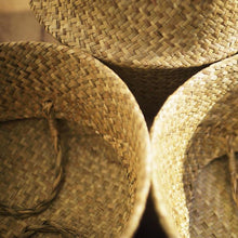 Load image into Gallery viewer, View from above on to folded natural seagrass wicker baskets
